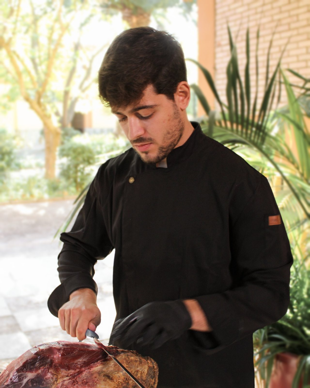 Néstor González hand-carving Iberian ham